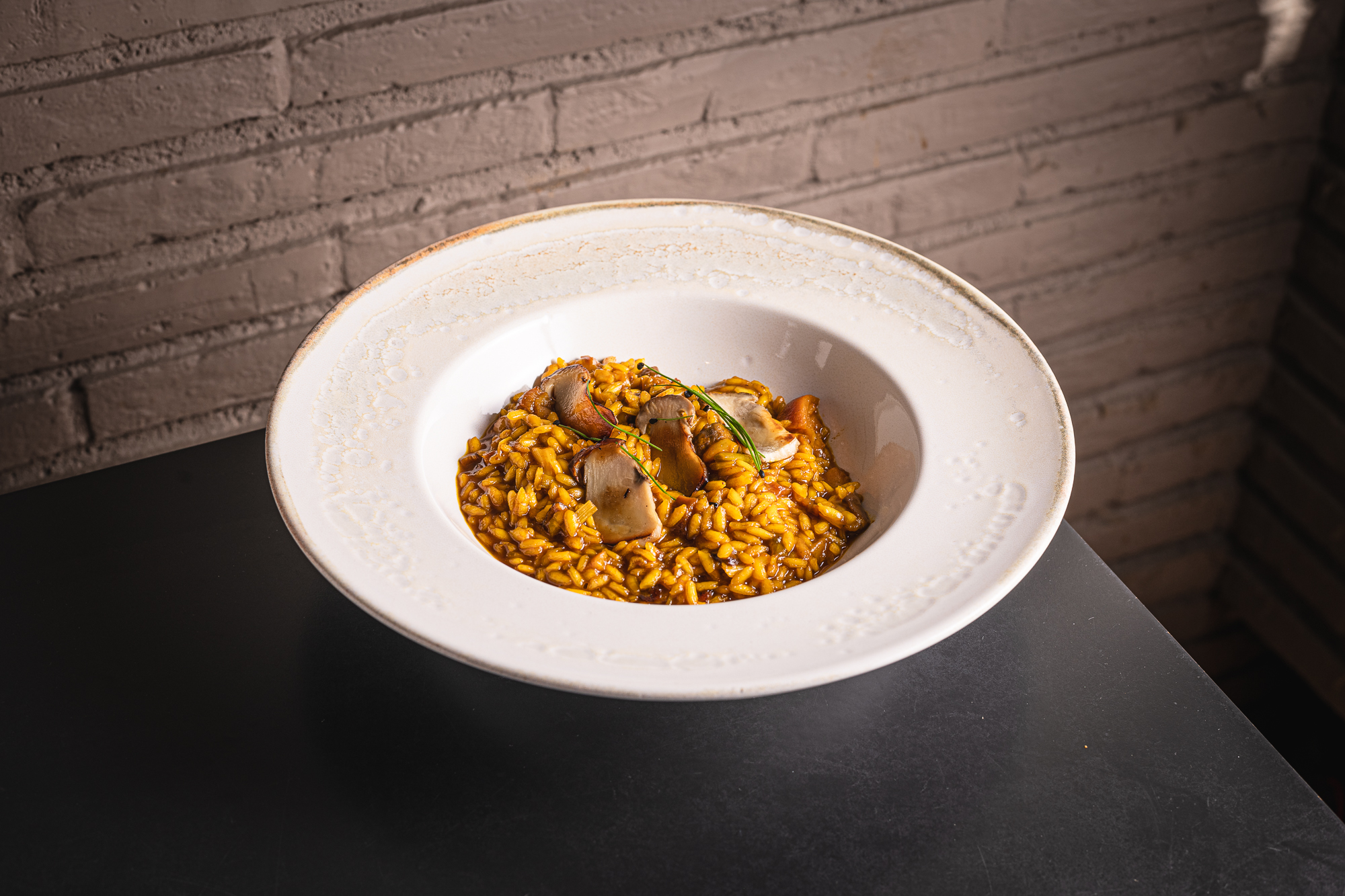 Arroz meloso de manitas y boletus