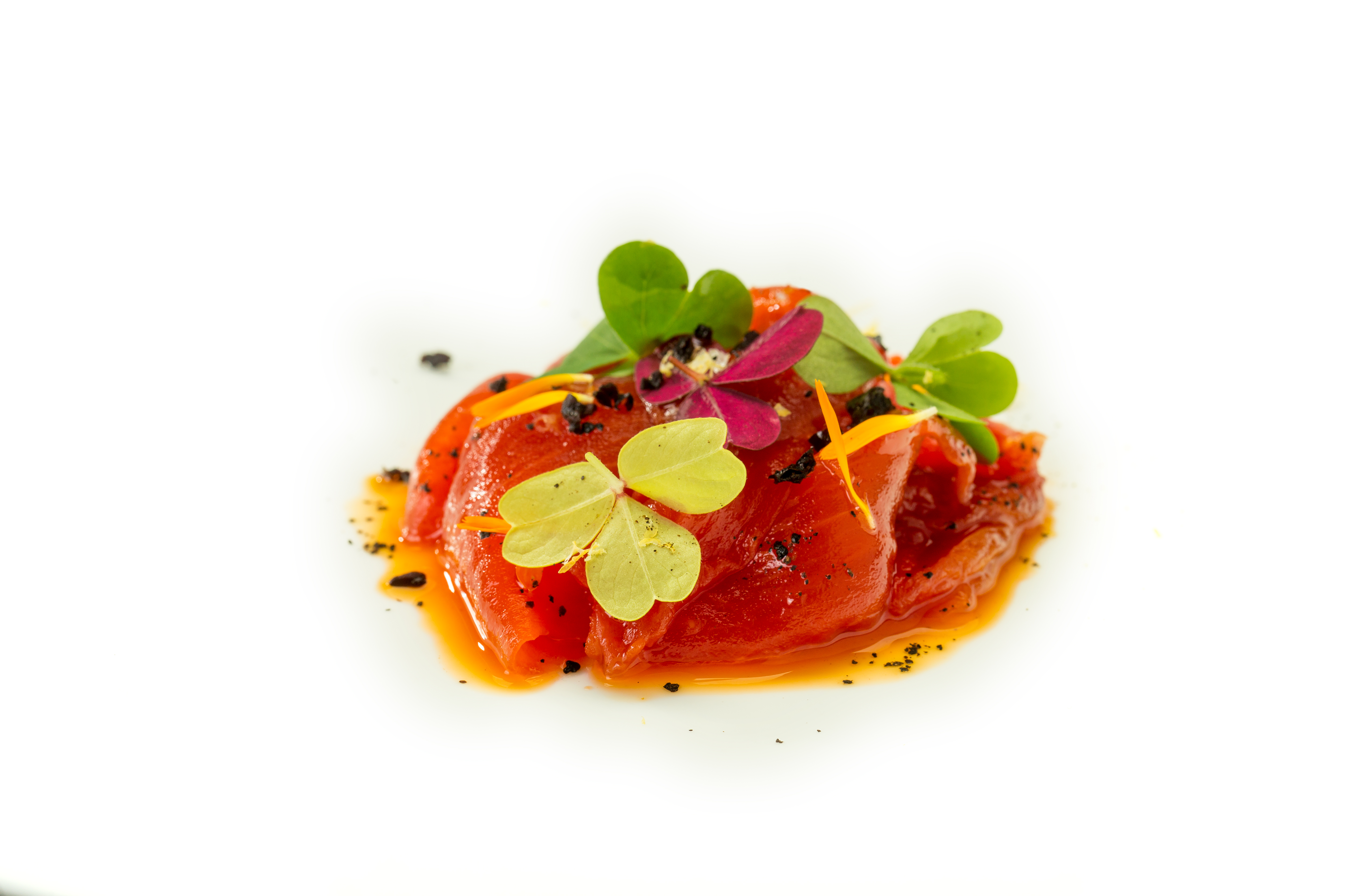 Lonchitas de sandía, aceite de chorizo y limón negro